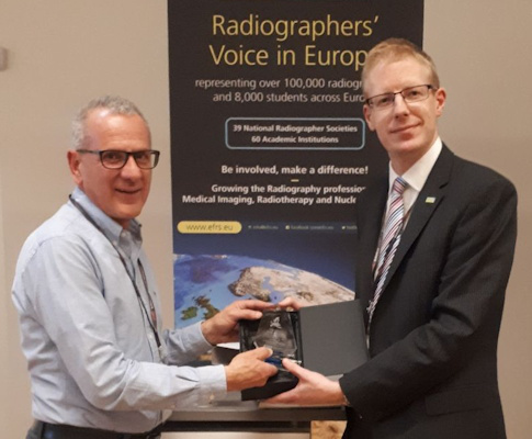 Paul Bezzina, PhD, receives an award from Jonathan McNulty, PhD, immediate past president of the European Federation of Radiographer Societies