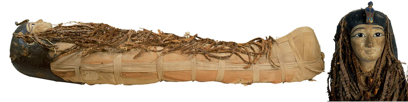 Right lateral view of the mummy of Amenhotep I shows the body fully wrapped in linen, covered from head to foot with floral garlands and wearing a head mask