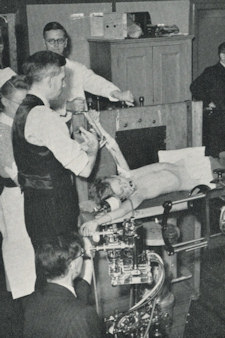 Patient in front of rotating cassette drum for angiocardiography